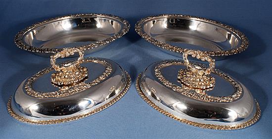 A pair of ornate Victorian oval silver plated entrée dishes with covers, length 278mm.